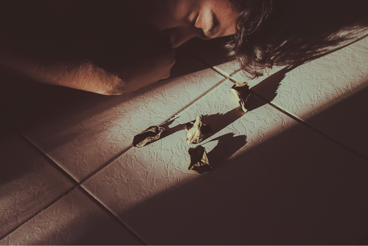 man laying on the floor with eyes closed