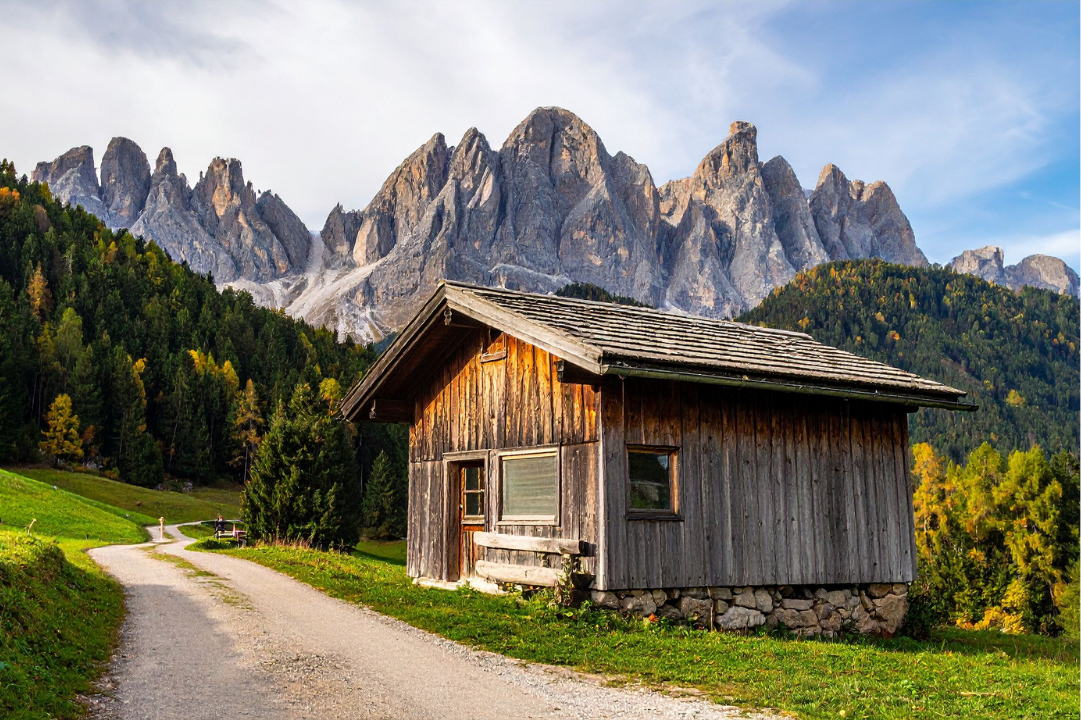 A rustic wooden cabin on a mountain path, evoking solitude and personal sanctuary